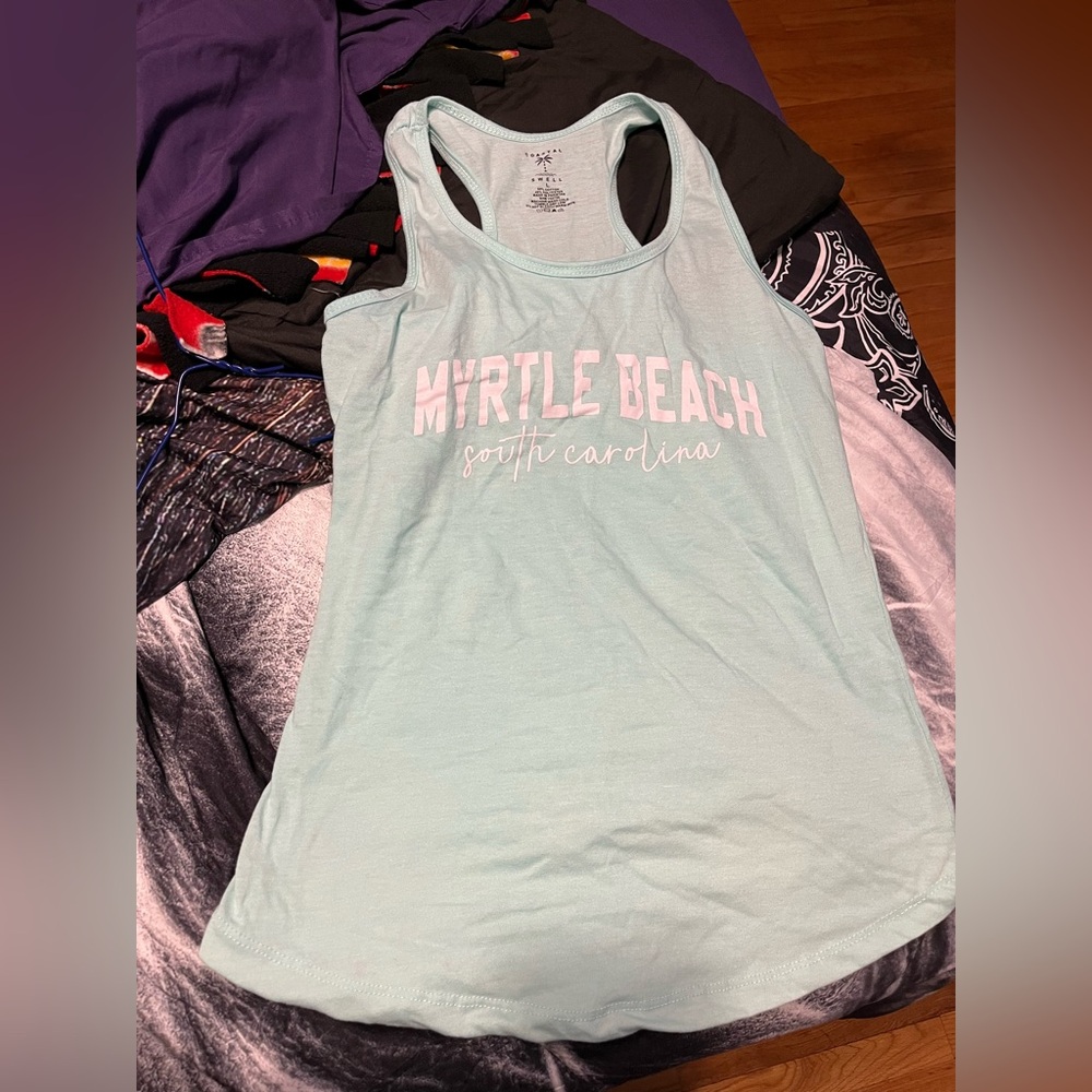 Light blue myrtal beach tank top says large, but really if it’s like a medium